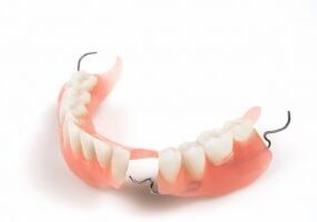Lower denture with braces on a white background. Horizontal position.